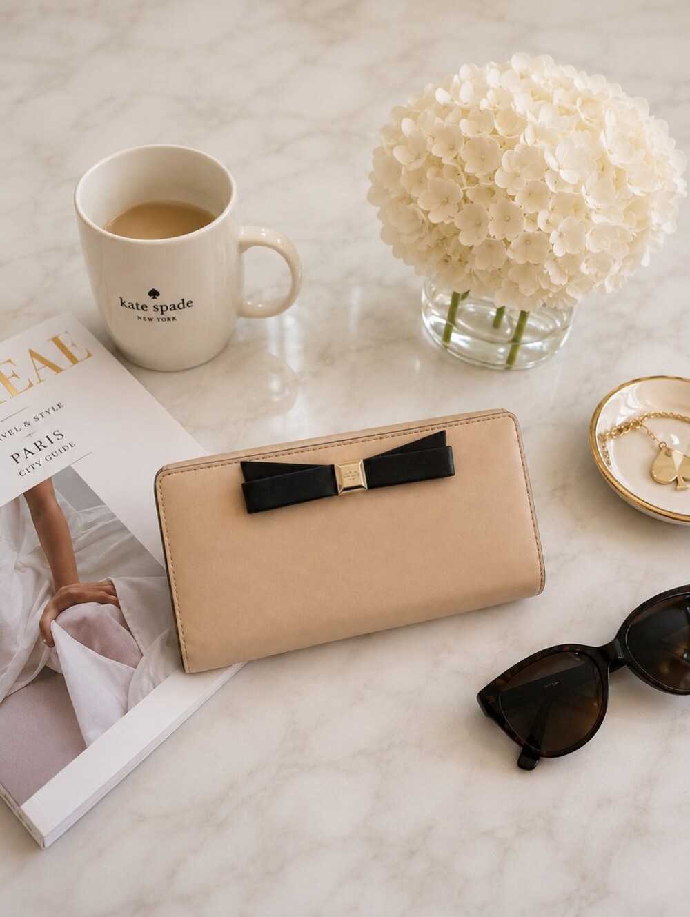 kate spade beige wallet with black bow and gold hardware